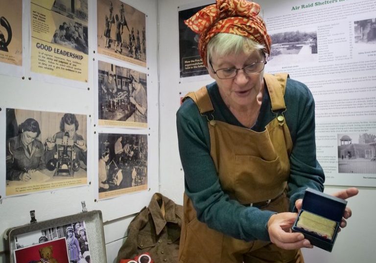 A Bexhill Museum Education Team volunteer with the WWI collection.