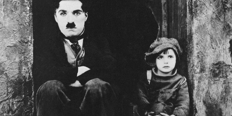 Charlie Chaplin & Jackie Coogan in a scene from The Kid. Charlie Chaplin & Jackie Coogan in a scene from The Kid.